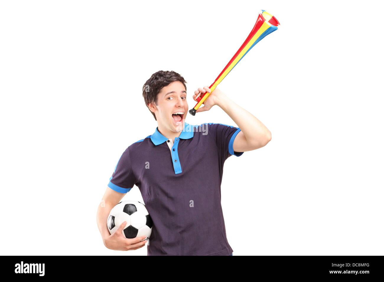 Male sport fan holding a football and horn Stock Photo Alamy