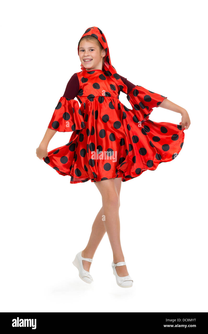 Girl dancing in a red polka-dot dress. Isolate on white. Stock Photo