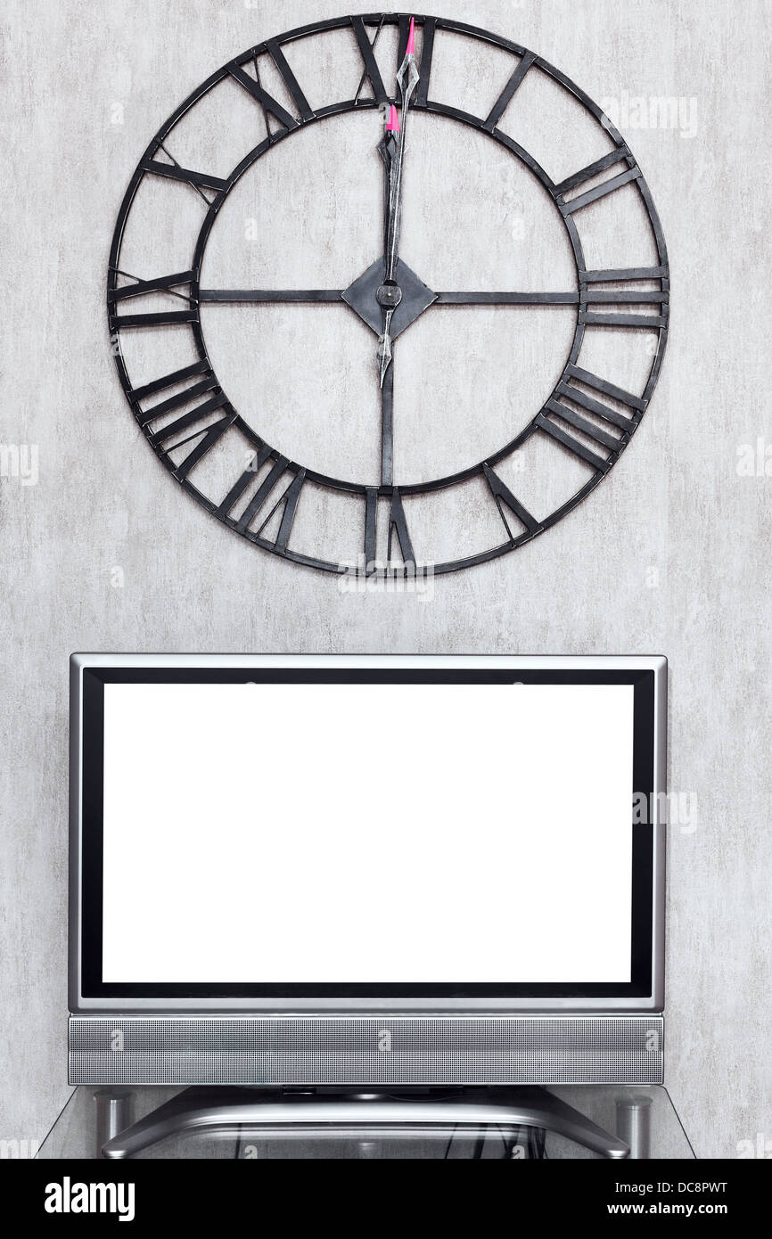 twelve o clock on wall clock under blank white screen of TV set Stock