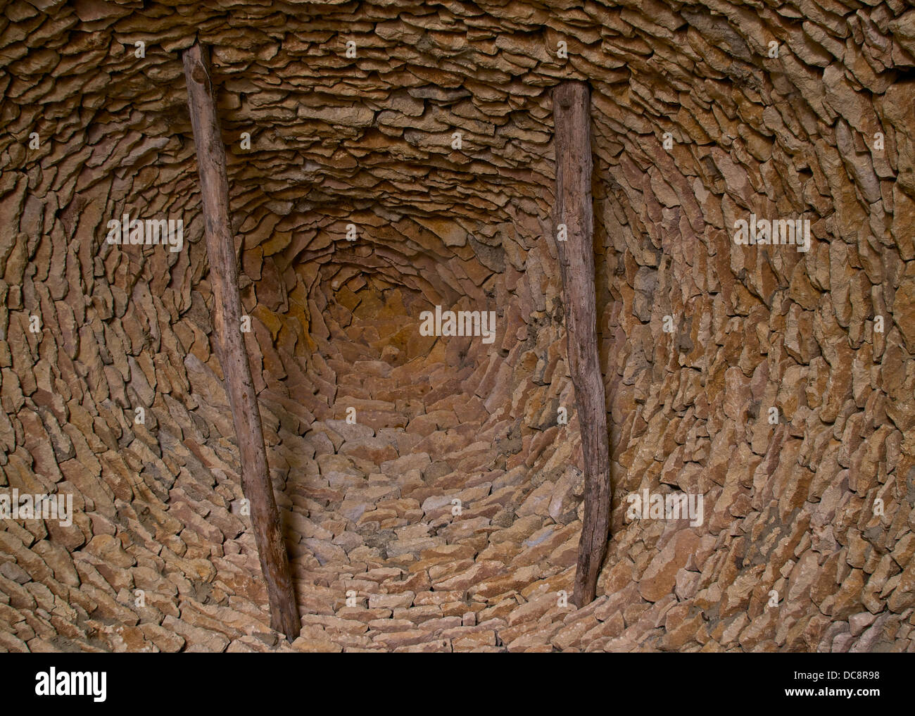 Inside of a Cabane du Breuil, view of the cantilevered corbeled dome vault, made with flat stones in limestone, called 'Lauzes'. Stock Photo