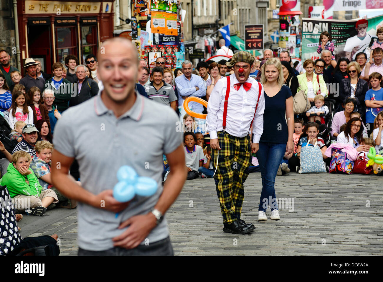 Royal Mile, Edinburgh, Scotland, UK, Monday, 12th August, 2013. Street Performer clown comedian Pedro Tochas from Portugal entertains a crowd with help from audience volunteers during the Edinburgh International Festival Fringe Stock Photo