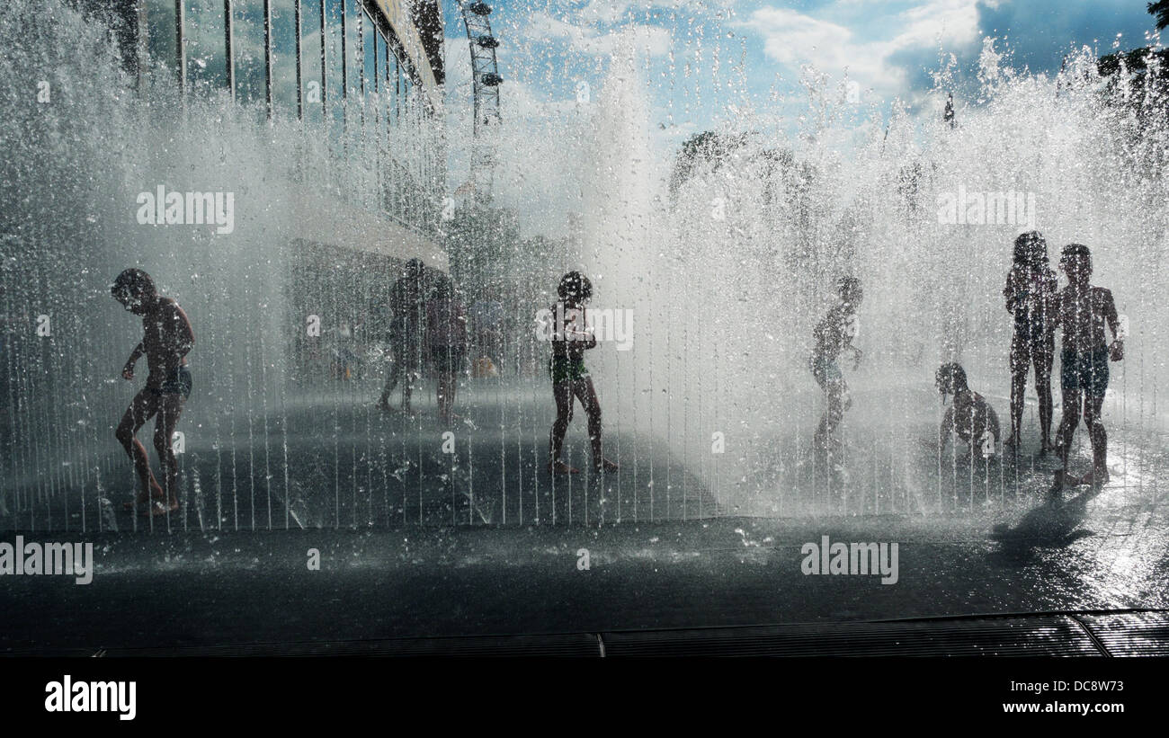 Kids playing in 'Appearing Rooms' water fountain by Jeppe Hein in summer outside Royal Festival Hall Southbank in South London England Stock Photo