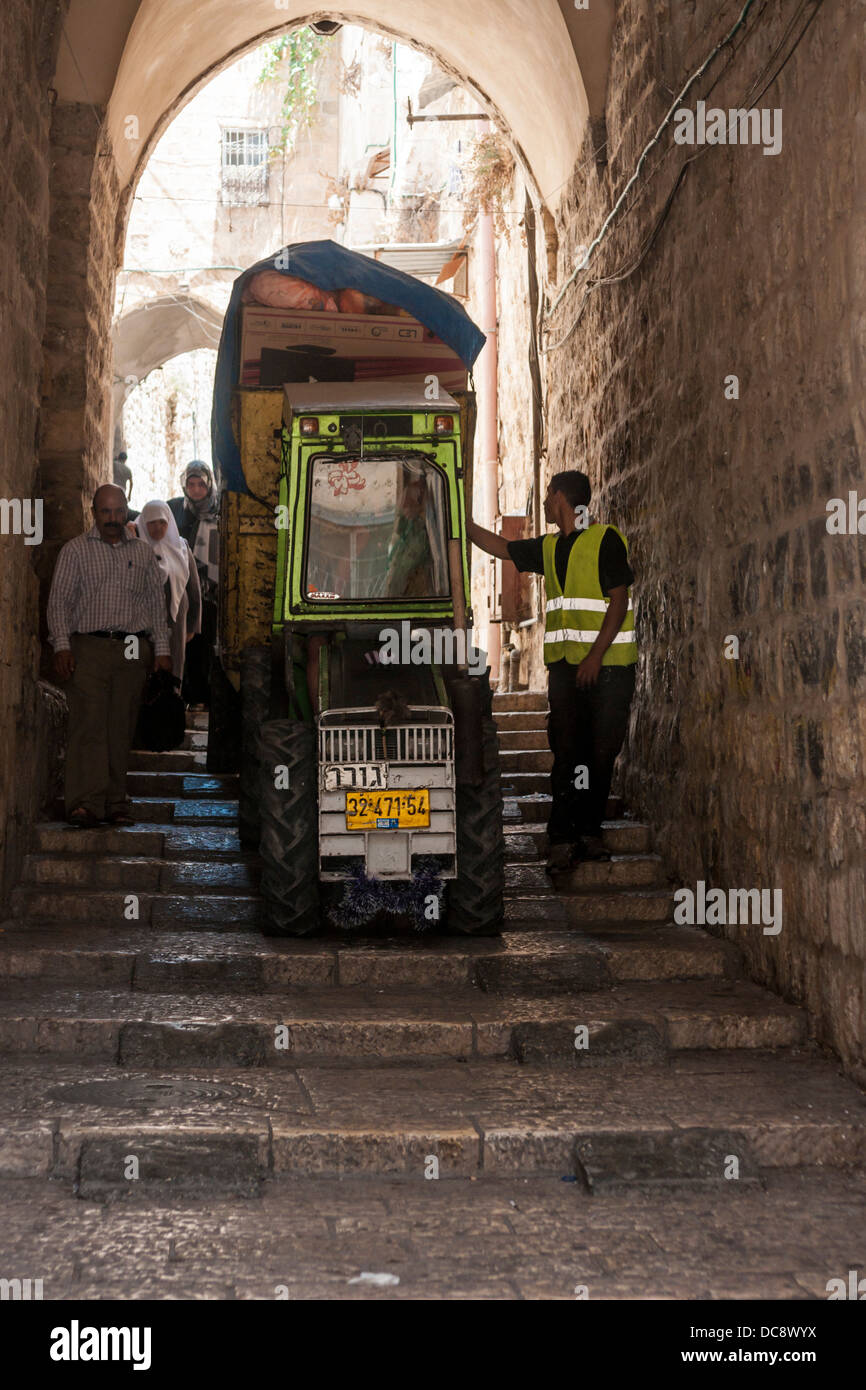 Jerusalem, Israel. A garbage-collecting mini-tractor drives down stairs in the narrow alleys of the old city Stock Photo