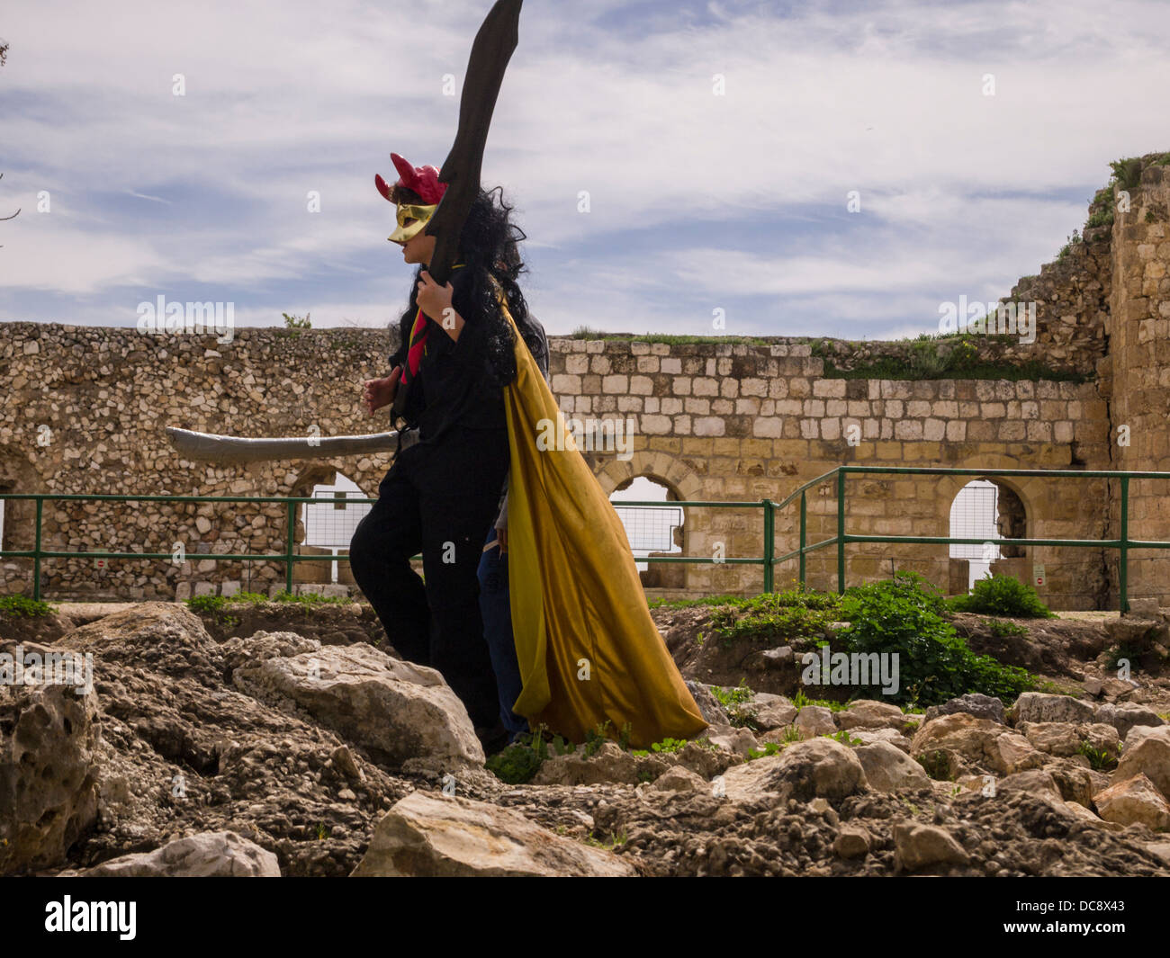 Rosh Haayin, Israel. A child with plastic swords and customs play medieval games at the ruins of a 16th century ottoman fort. Stock Photo