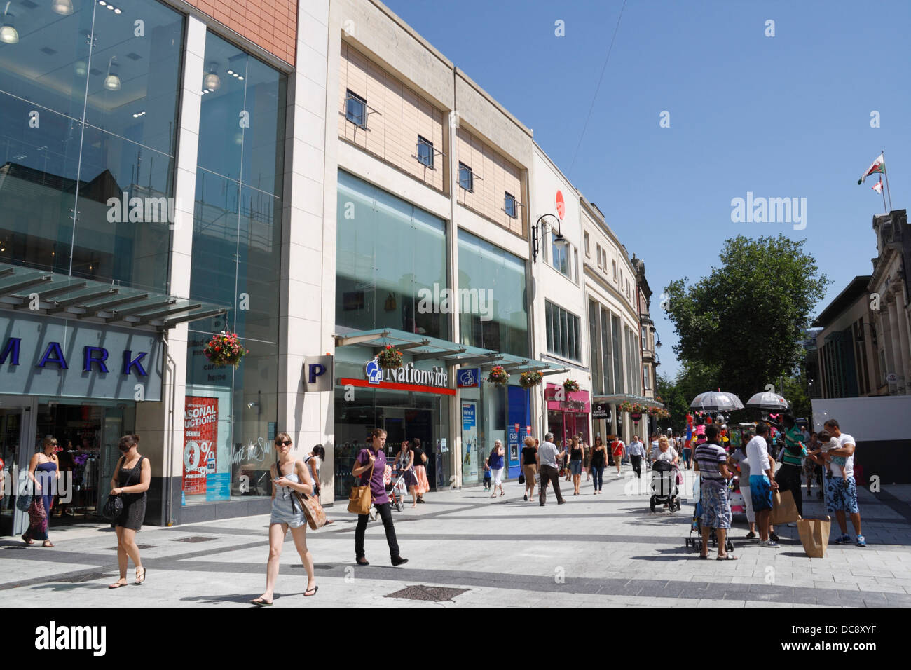 People Shoppers walking along Queen Street in Cardiff city centre Wales UK. Streetscene Pedestrian street Stock Photo