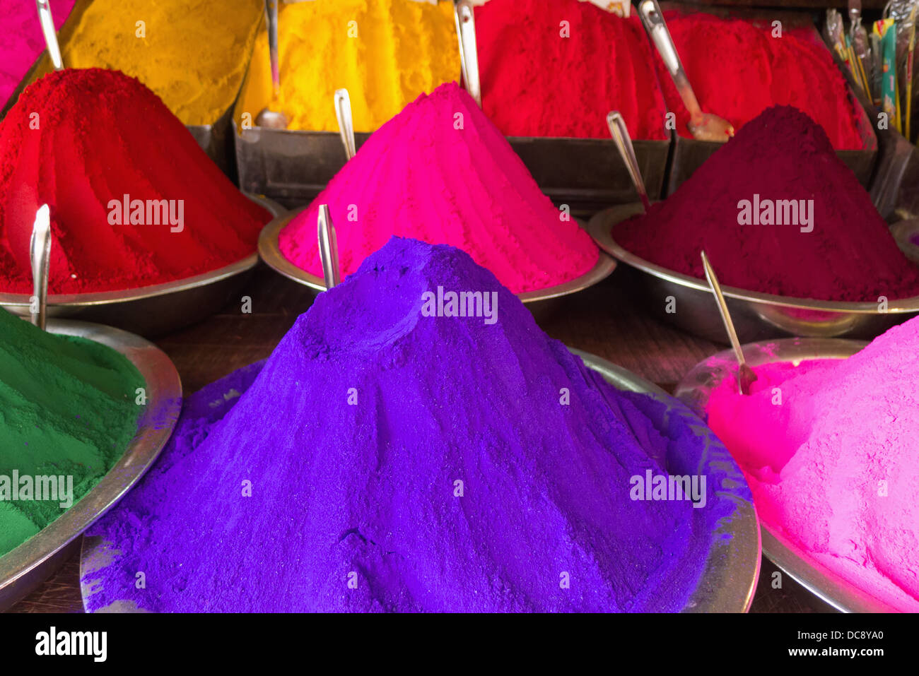 Conical piles of kumkum (coloured powder used for bindi dots and pujas) at Devaraja Market; Mysore, Karnataka, India Stock Photo