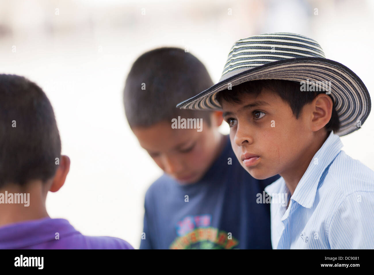 A young Colombian boy wears a traditional sombrero vueltiao in the plaza of Villa de Leyva in the Boyaca department of Colombia Stock Photo