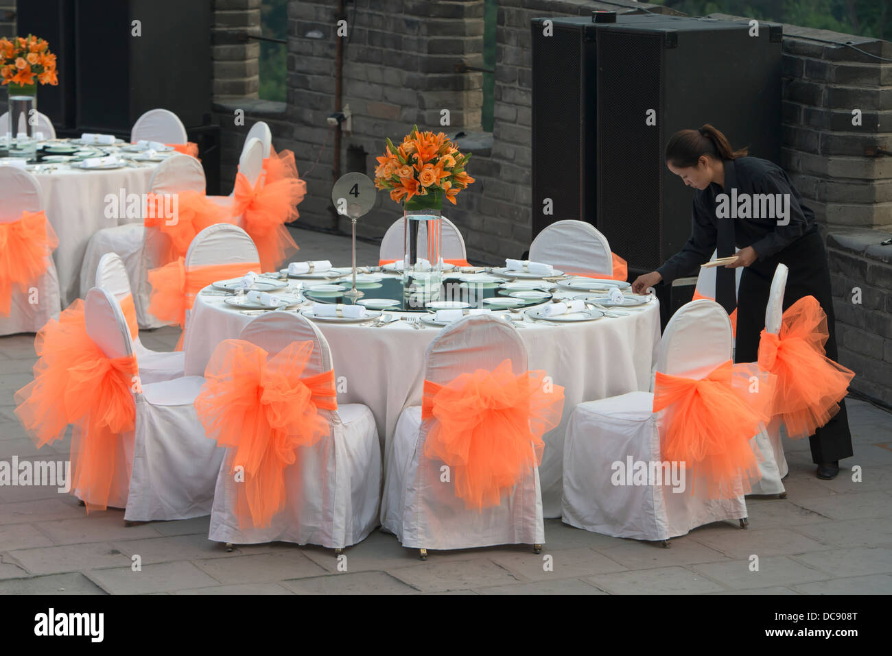 A worker sets up a formal table for a wedding celebration; Beijing, China Stock Photo