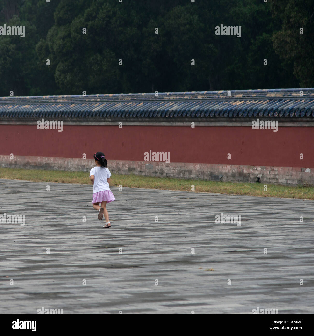 A young girl walks on a pathway at the Temple of Heaven; Beijing, China Stock Photo