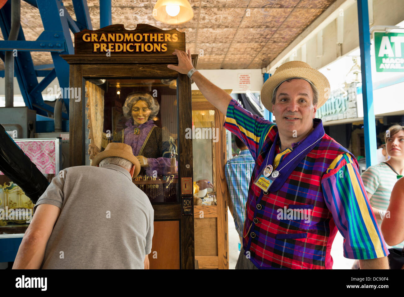 Brooklyn, New York, USA. 10th August 2013. At Coney Island, BOB YORBURG, AKA Professor Phineas FeelGood, of Yorktown Heights, points to Grandmothers Predictions, the world famous fortune telling game he restored after it was damaged during Hurricane Sandy, in October 2012. At 3rd Annual Coney Island History Day celebration. Stock Photo