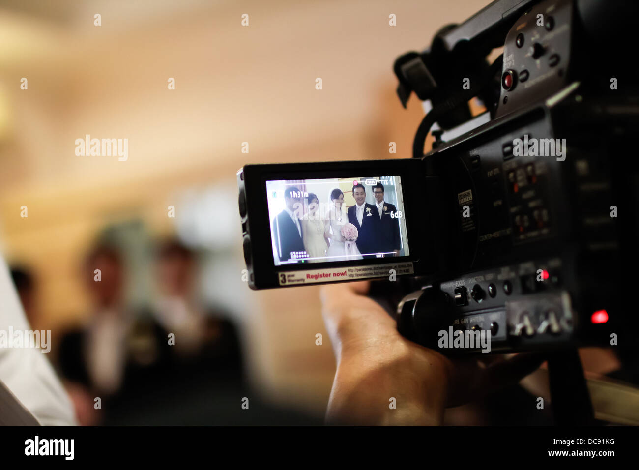 Video camera recording a wedding ceremony in the bride's house Stock