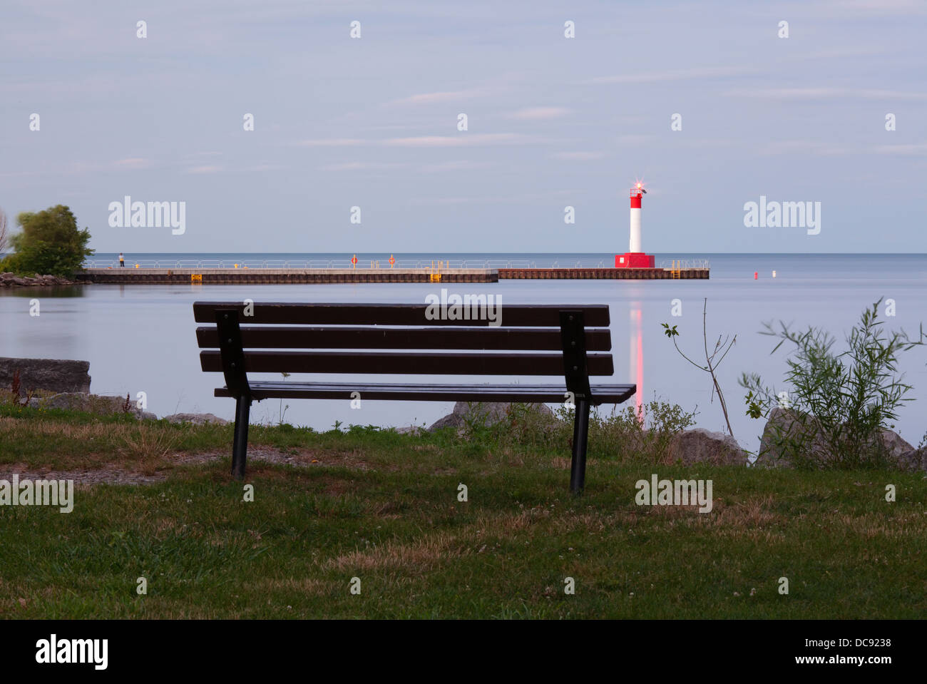 Long exposure of a lighthouse and bench ooverlooking Lake Ontario, Oakville, Ontario, Canada. Stock Photo