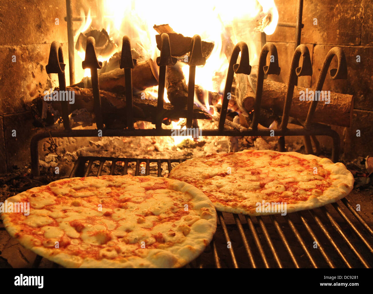excellent fragrant pizza baked in a wood fireplace with a wood-burning oven pizzeria 1 Stock Photo