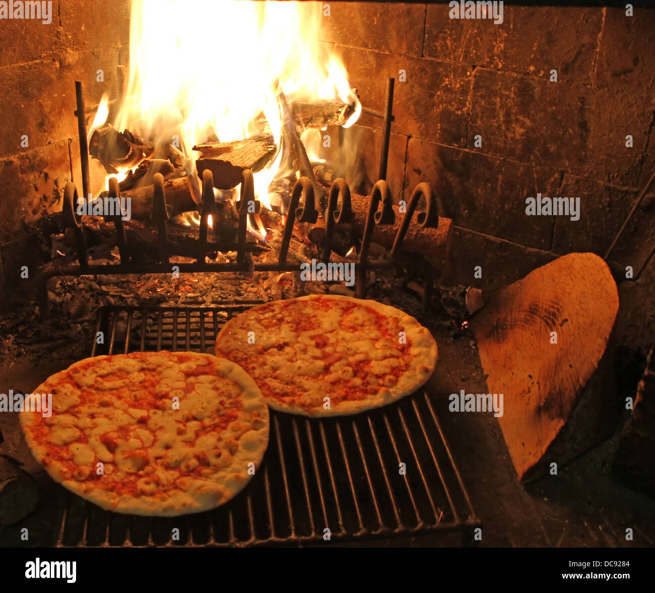 excellent fragrant pizza baked in a wood fireplace with a wood-burning oven pizzeria 2 Stock Photo