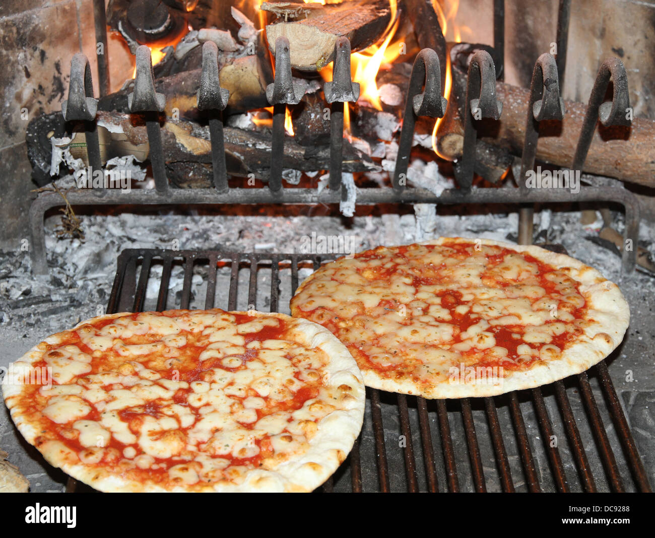excellent fragrant pizza baked in a wood fireplace with a wood-burning oven pizzeria 4 Stock Photo