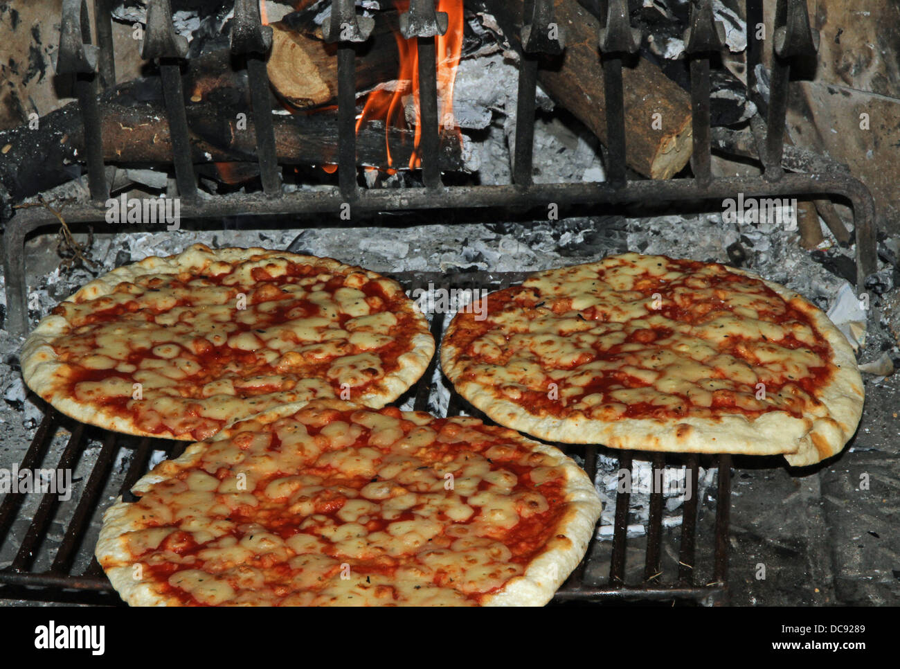 excellent fragrant pizza baked in a wood fireplace with a wood-burning oven pizzeria 5 Stock Photo