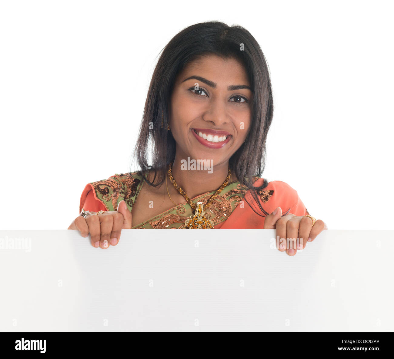 Traditional indian woman in sari holding a blank billboard portrait of