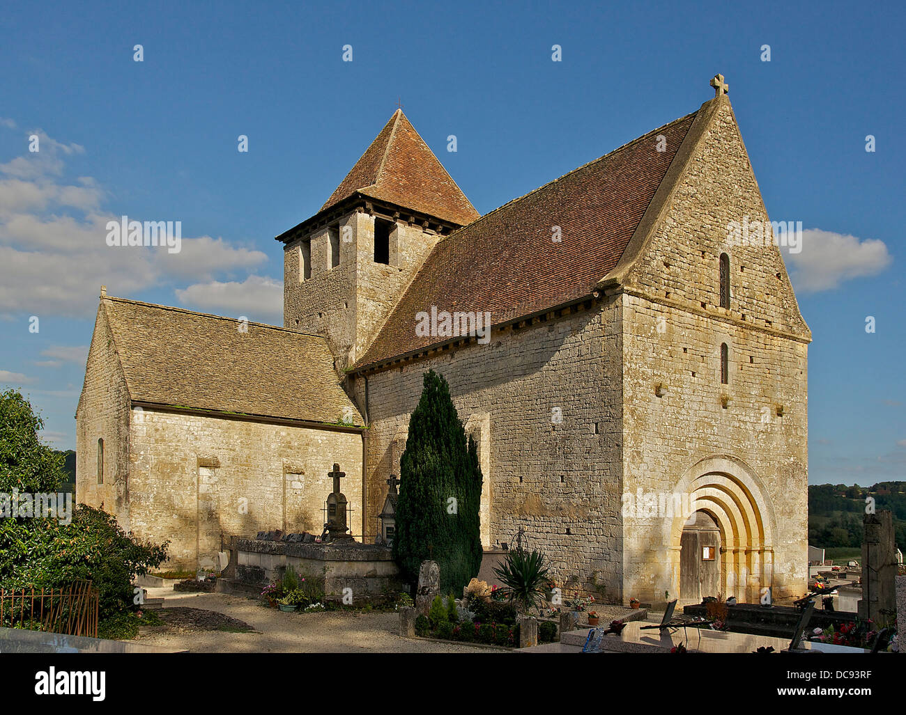 In Limeuil Dordogne, France, this 12th century Romanesque church and 13th & 14th centuries side chapel. Roof built in lauze sto Stock Photo
