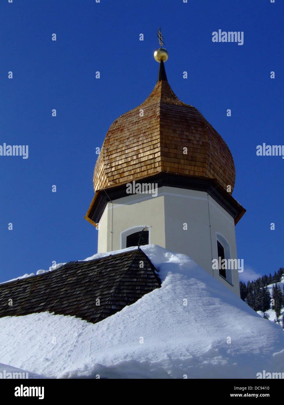Austrian onion dome church spire covered in snow. Stock Photo