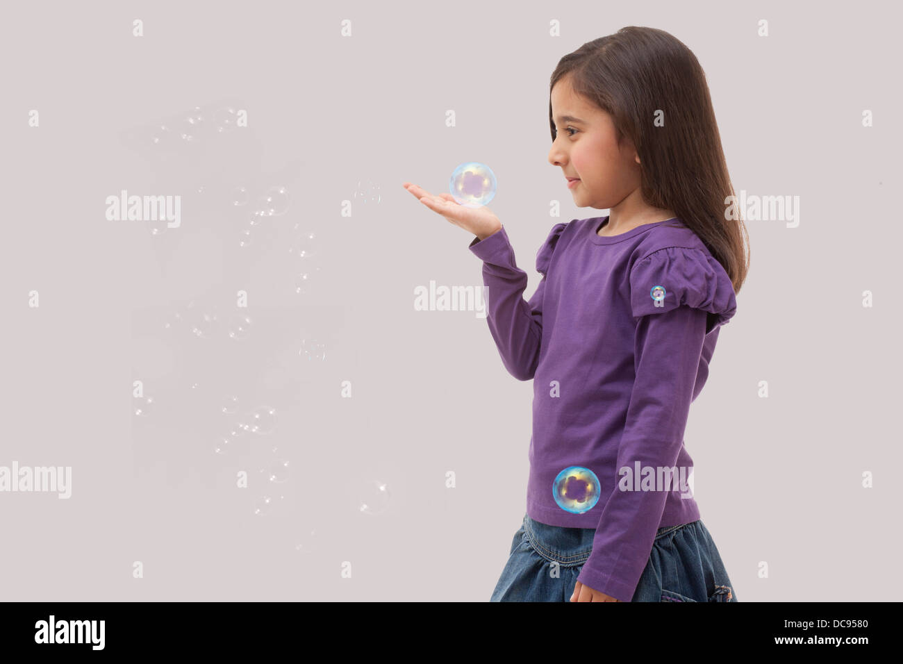 Young girl holding a bubble in her her hand Stock Photo - Alamy