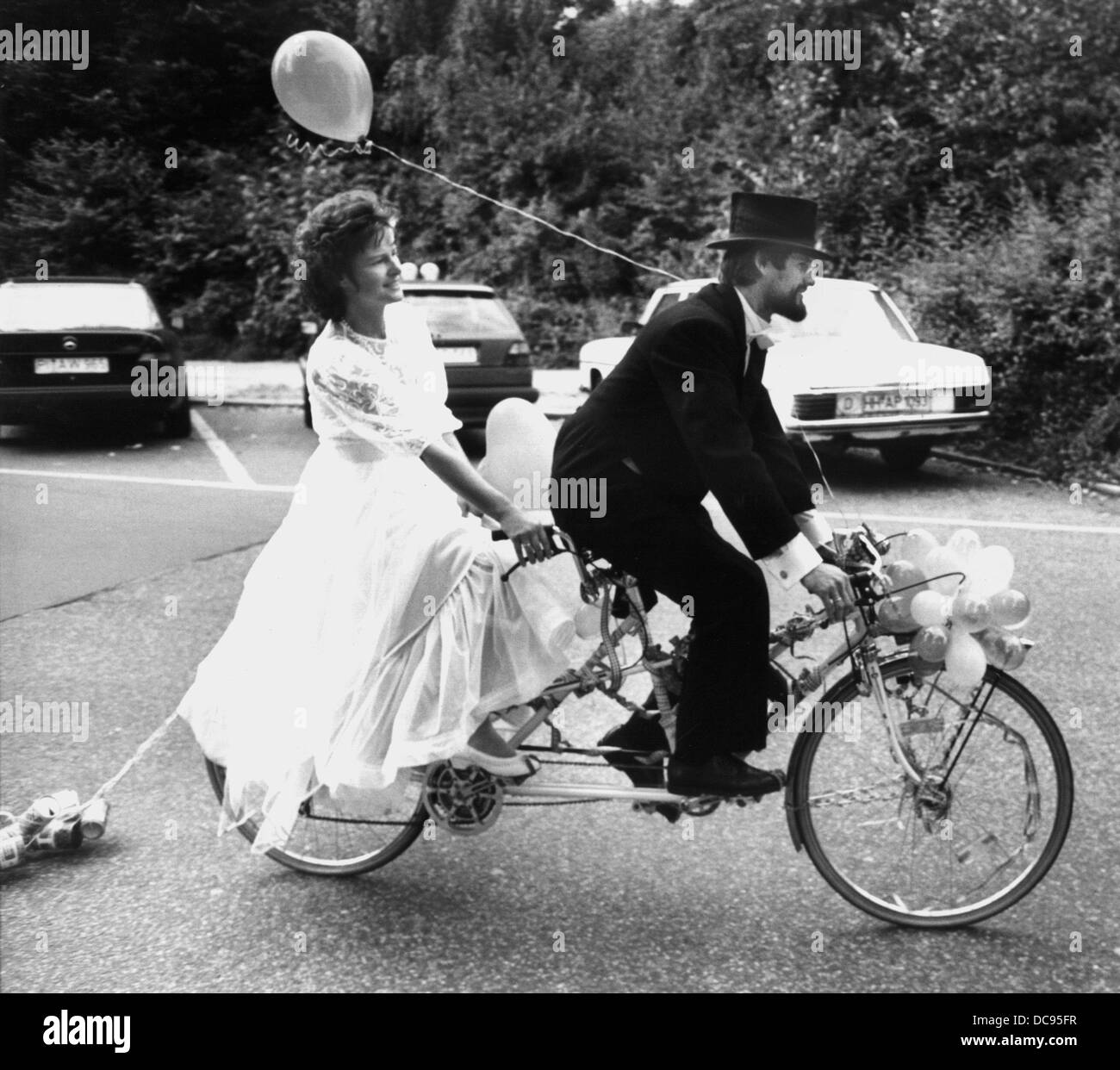 The bridal couple Karin Hintz and Jörn Bode are environmental friendly and cycle to the church on the 30th of August in 1988 in Hamburg. Stock Photo