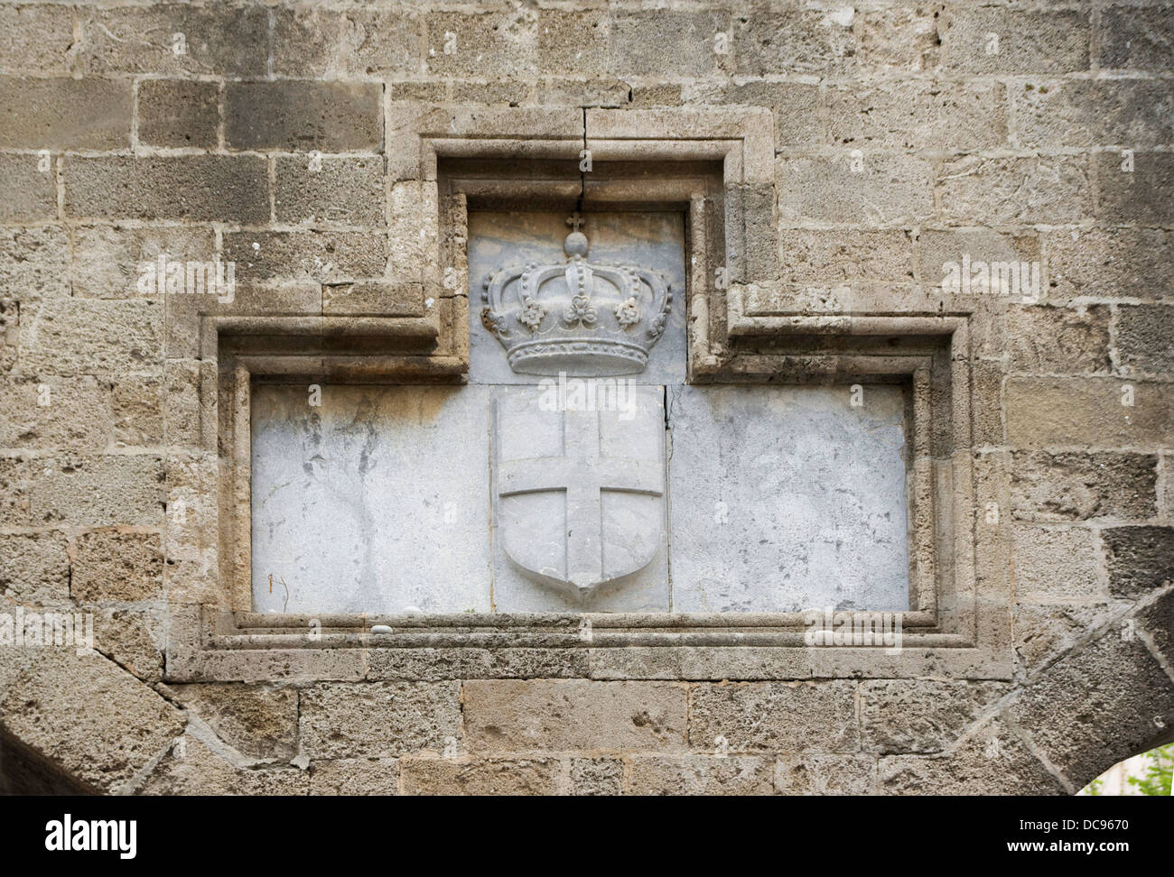 The royal Coat of Arms of the House of Savoy on the city walls of Rhodes, Greece, during the italian occupation of the island. Stock Photo