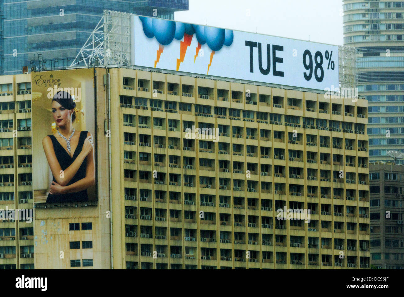 Hong Kong. 13th August 2013.  A building in Kowloon, Hong Kong shows the weather forecast as 98% of thunderstorms during Typhoon Utor. Typhoon Utor (known in the Philippines as Typhoon Labuyo) is an active tropical cyclone located over the South China Sea. The eleventh named storm and second typhoon of the 2013 typhoon season, Utor formed from a tropical depression on August 8. The depression was upgraded to Tropical Storm Utor the following day, and to typhoon intensity just a few hours afterwards. Credit:  ZUMA Press, Inc./Alamy Live News Stock Photo