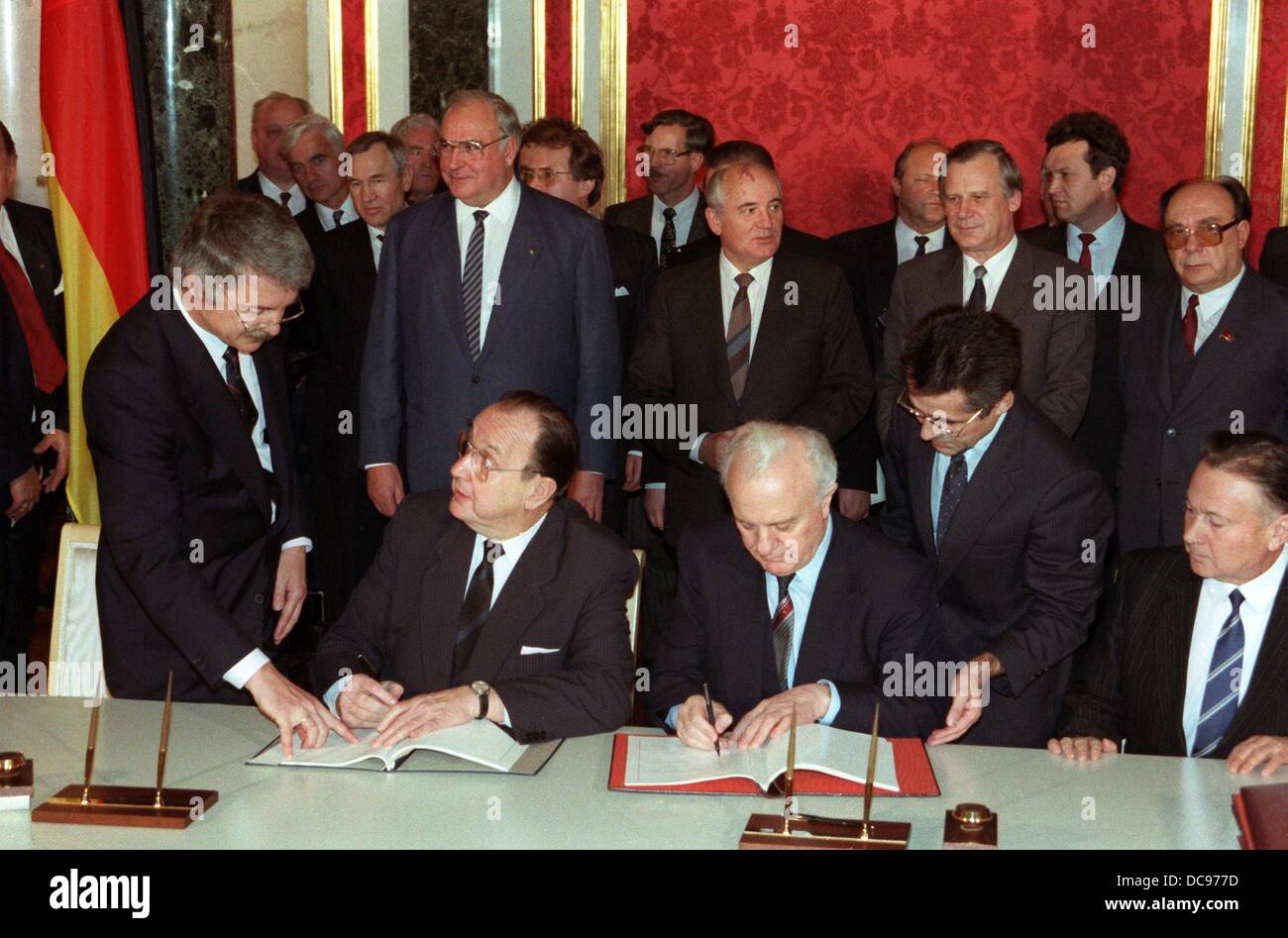 German foreign minister Hans-Dietrich Genscher (M, left) and his Soviet colleague Eduard Shevardnadze (M, right) sign a treaty about a German credit in Moscow. Behind Genscher is Helmut Kohl, behind Shevardnaze is Soviet president Mikhail Gorbachev. The German delegation stayed in the Soviet Union for a state visit from the 24th to the 27th of October in 1988. Stock Photo