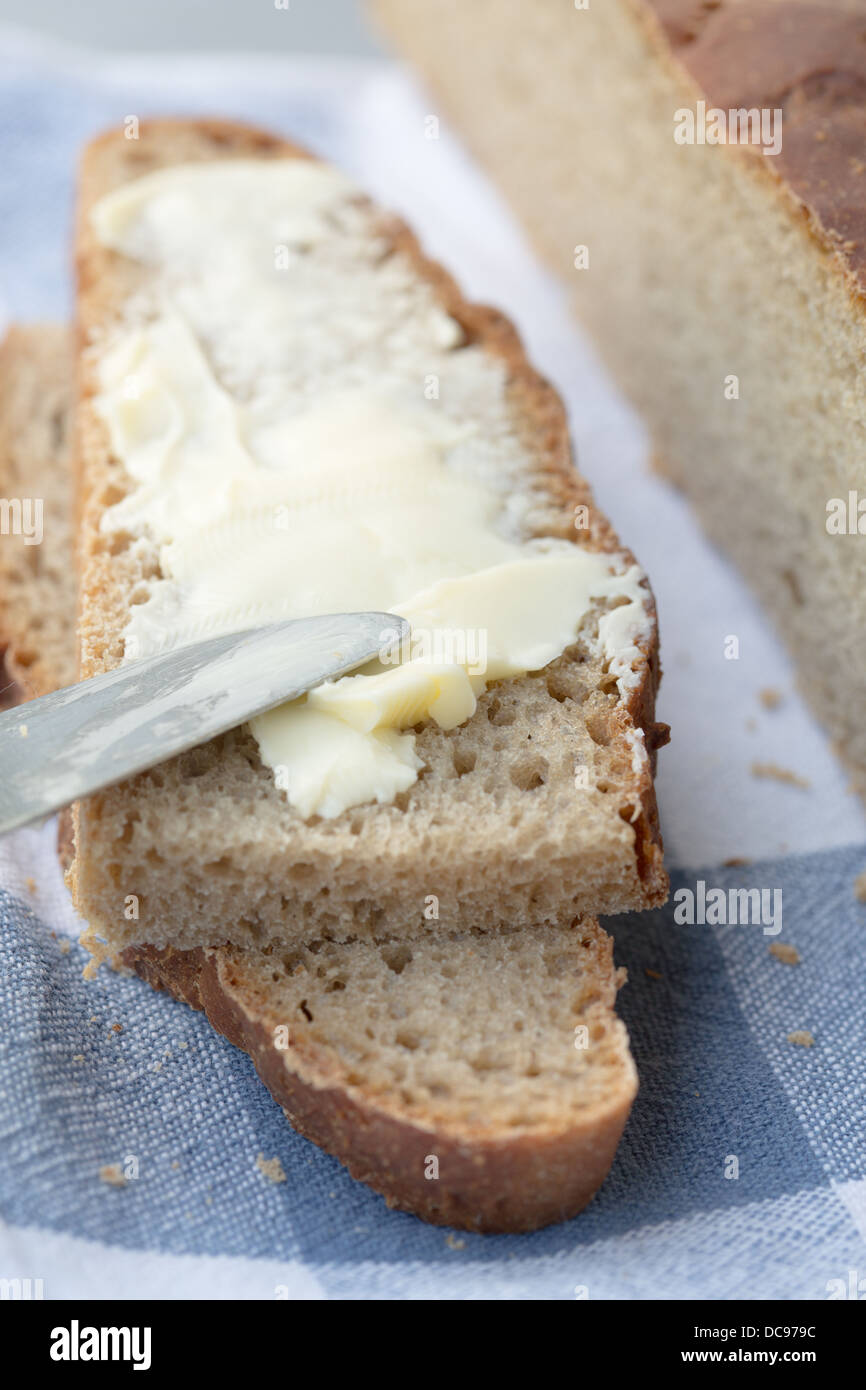 Slices of wholemeal bread with butter Stock Photo