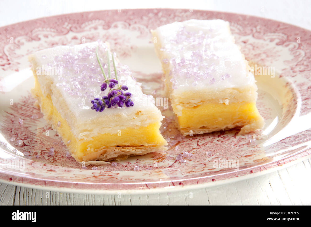 custard cake with lavender and purple sprinkle on a plate Stock Photo