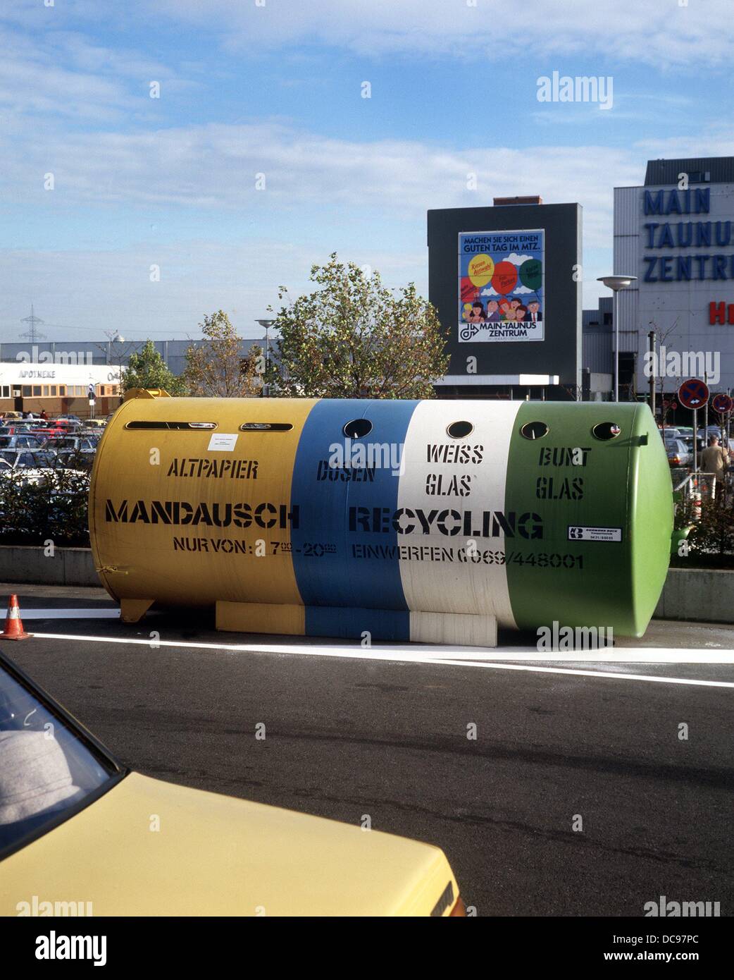 A container for recycling of waste paper, glasses and tins at the end of the 1980s near the shopping centre Main-Taunus-Zentrum near Frankfurt am Main. Stock Photo