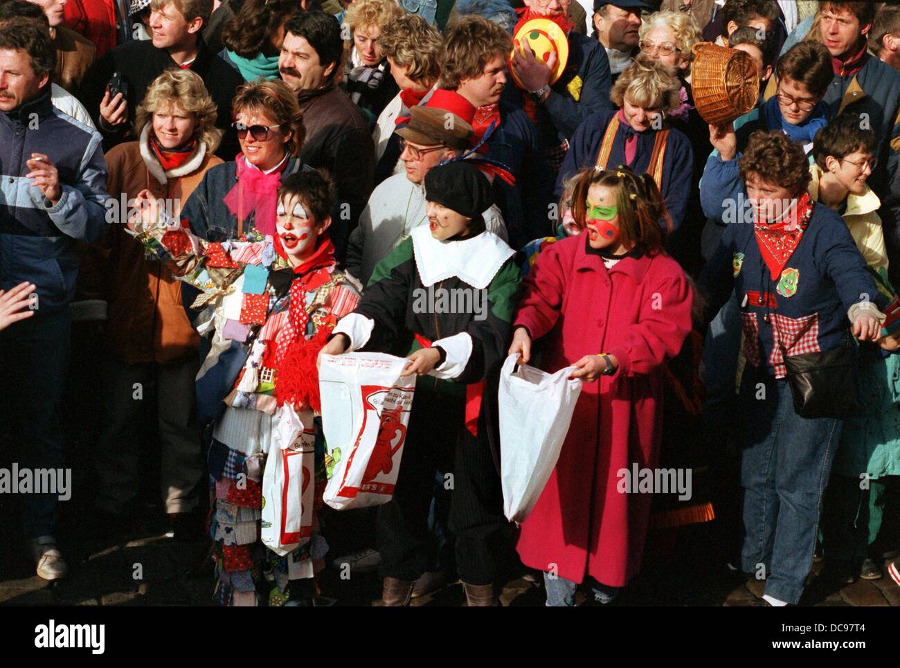 Masked children wait for candies at the Rose Monday parade in Duesseldorf on the 15th of February in 1988. Stock Photo