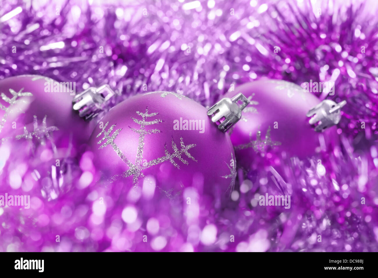 background from violet christmas balls with tinsel Stock Photo