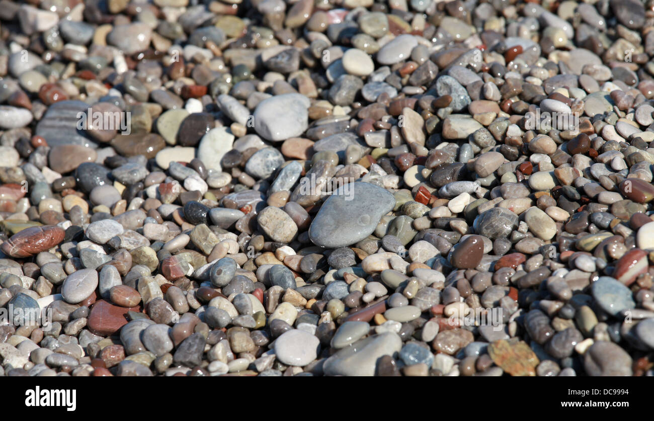 Wet sea coastal colorful stones background Stock Photo