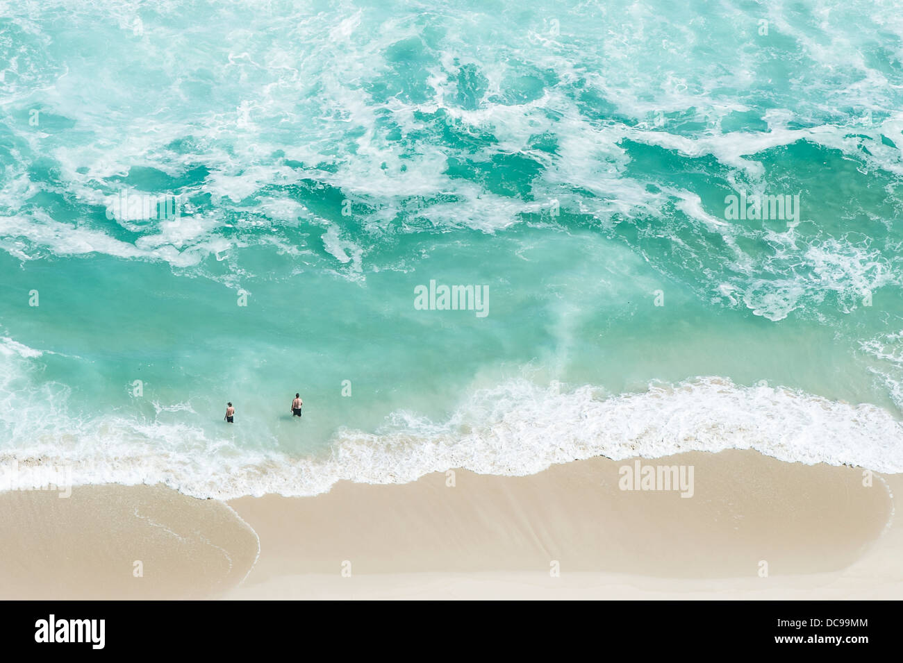 Aerial shot of people swimming at the beach Stock Photo