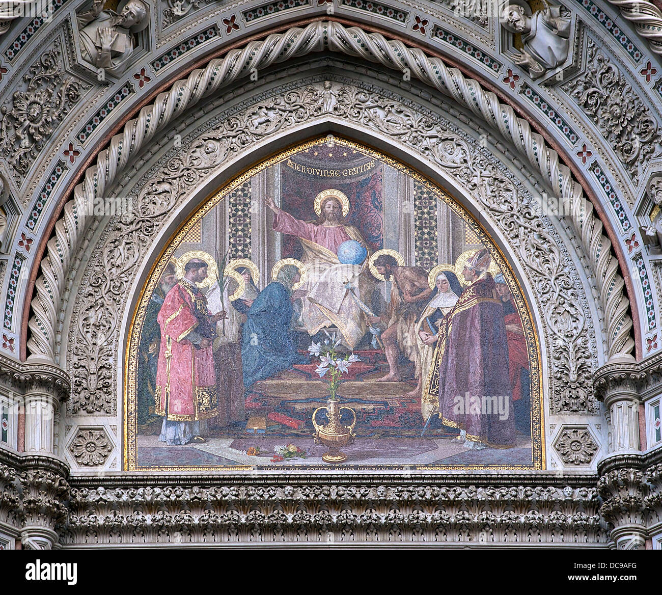 The 19th century gothic revival mosaic of the central tympanum (above the main gate) of the cathedral Santa Maria del Fiore in Stock Photo