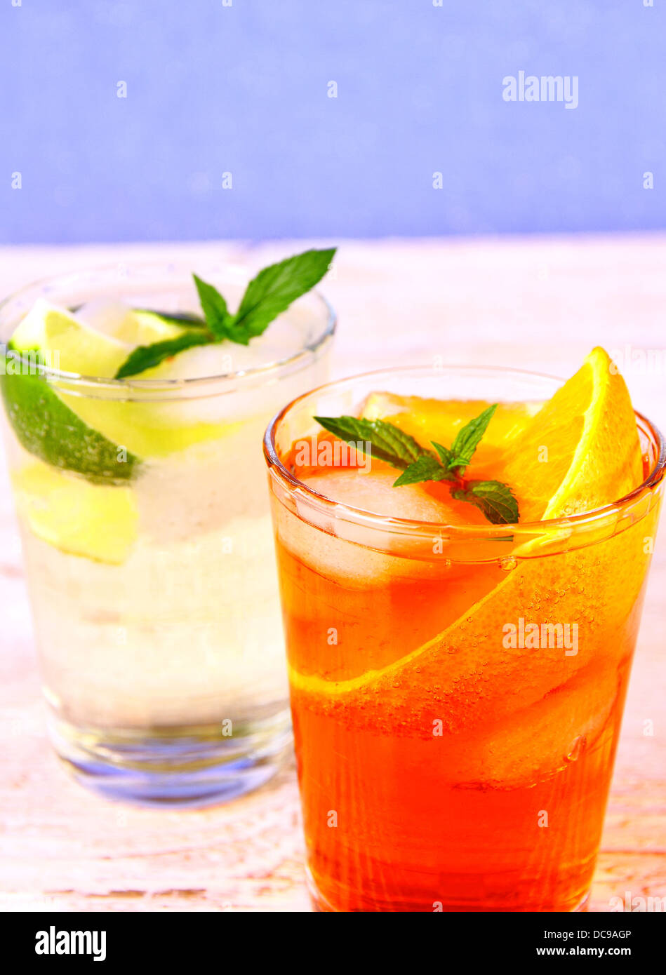 Orange, elderflower cocktails on blue background, close up Stock Photo
