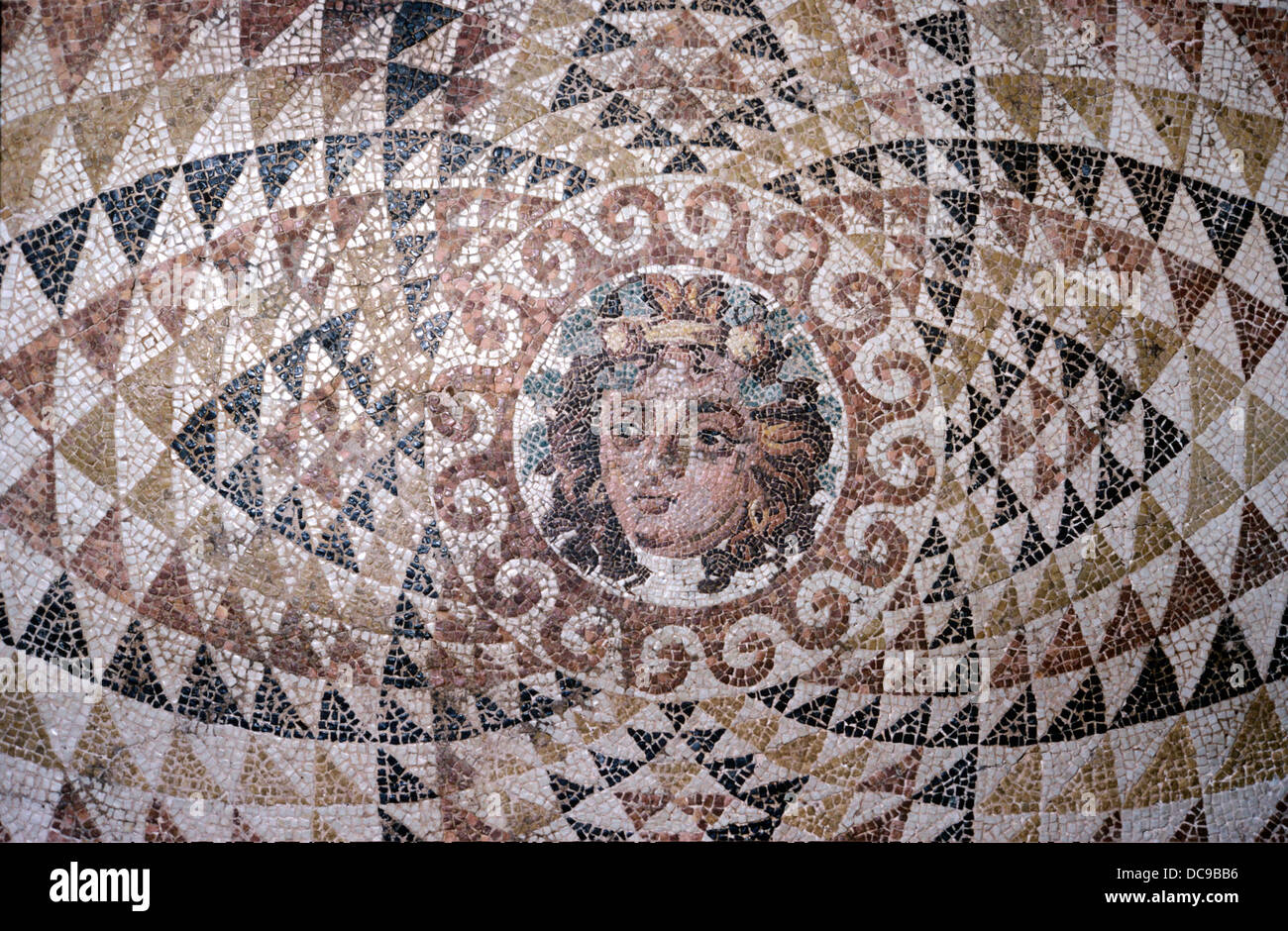 Mosaic floor showing head of Dionysus set in a pattern of triangles. From Roman villa. Corinth. Circa 2nd cent . AD/CE.  Corinth, Archaeological Museum of Ancient Corinth, Greece Stock Photo