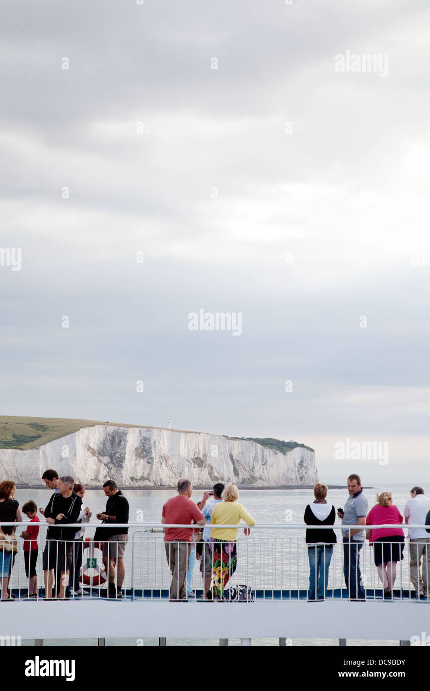 Cross channel car ferry passengers looking at the White cliffs of Dover ...