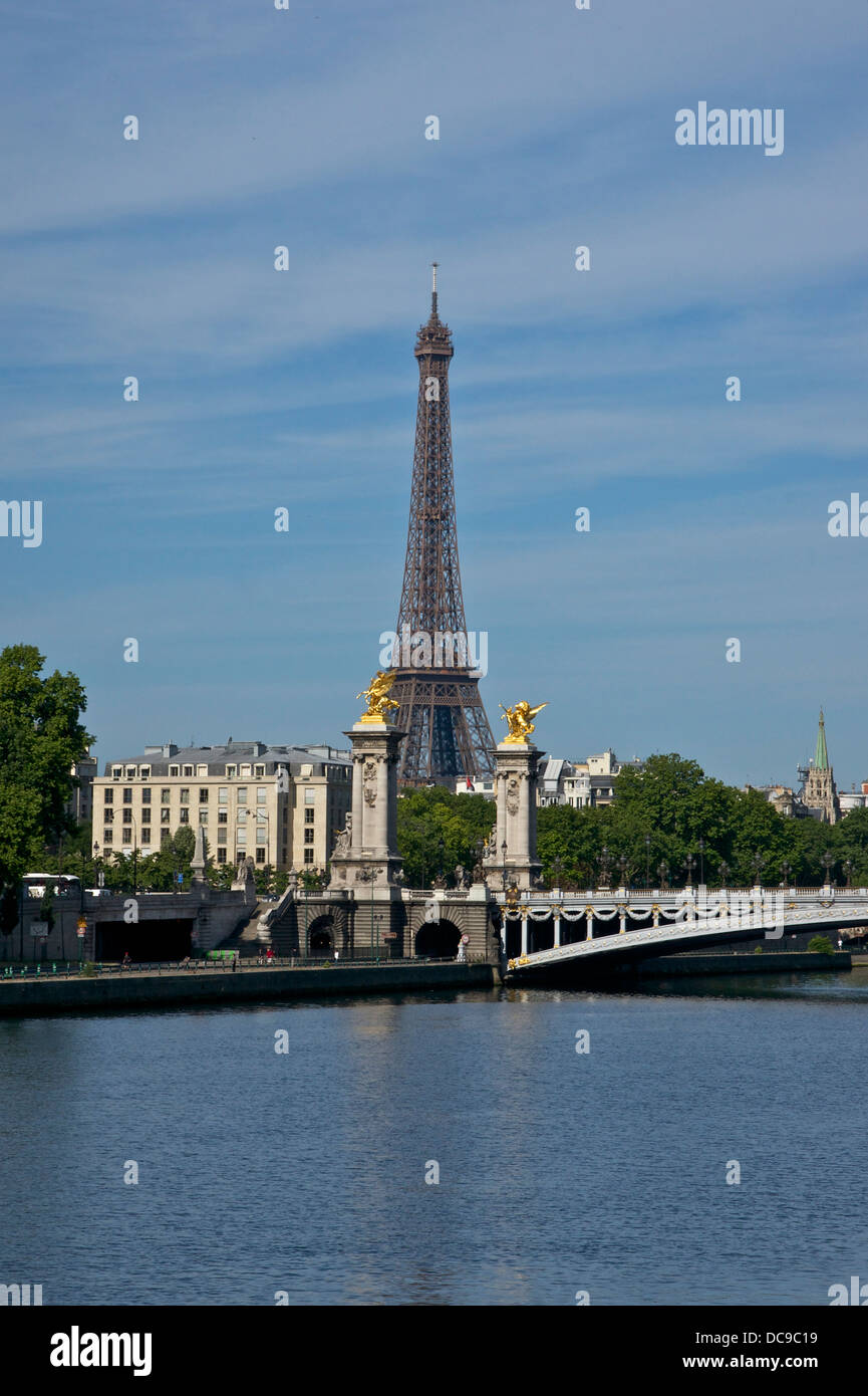 Eiffel Tower from northeast, between two statues of the Alexandre III bridge in Paris. Stock Photo