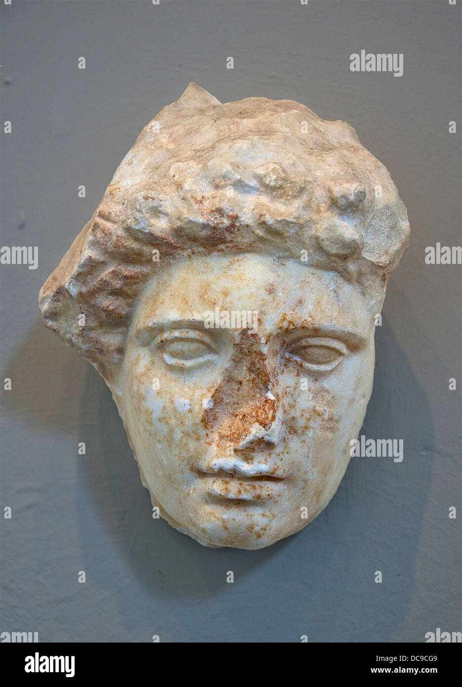 Head of a mourning female, a fragment from a grave stele. Stock Photo