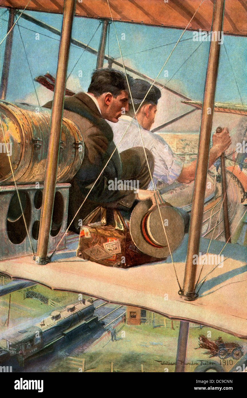 Biplane with pilot and passenger flying over a railroad train, 1910 ...