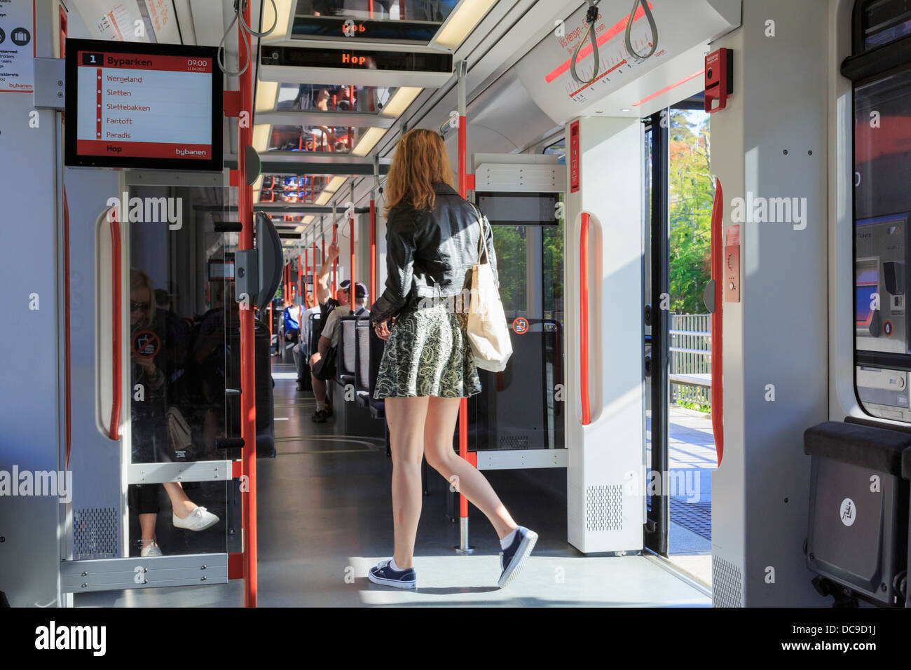 Female passenger entering a carriage on the Bergen Light Rail local transit system in Norway, Scandinavia Stock Photo