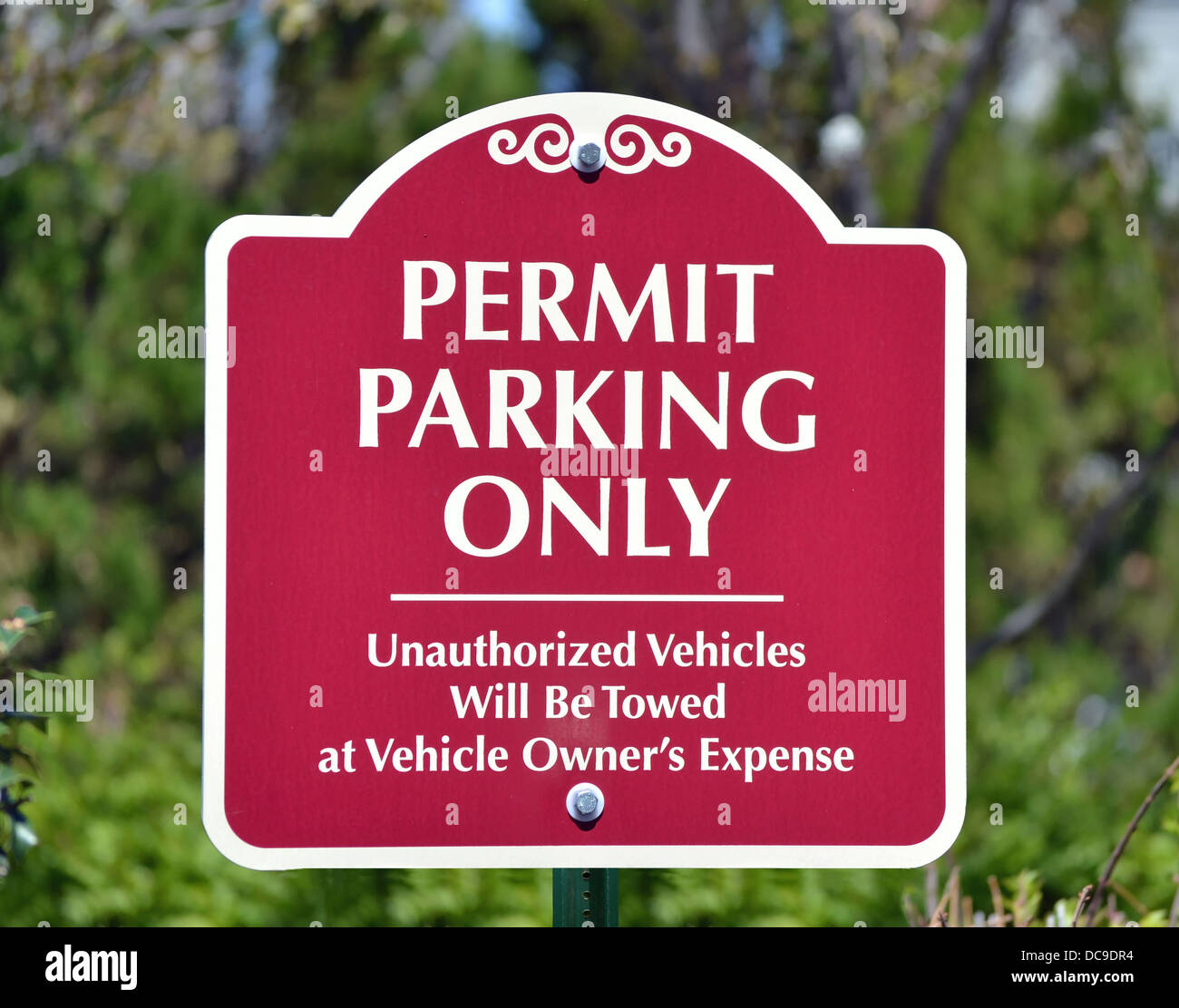 A red sign reading Permit Parking Only Stock Photo