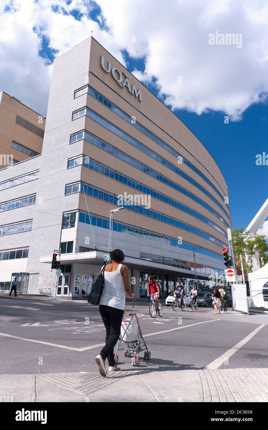 Woman pushing a stroller on De Maisonneuve boulevard in Montreal Stock