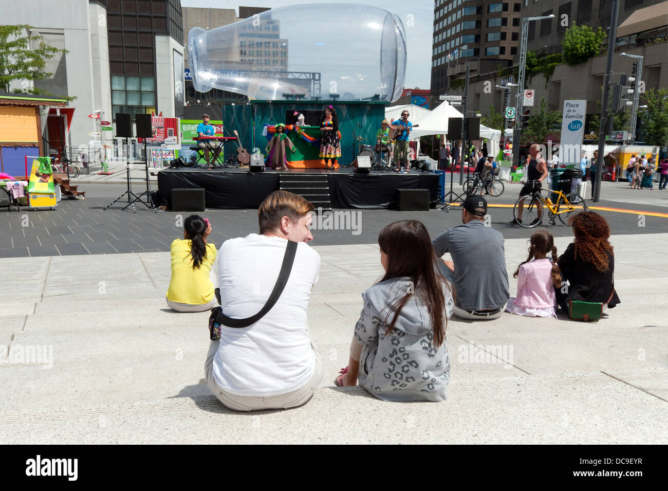 Mother and daughter attending an outdoor show for children. Stock Photo