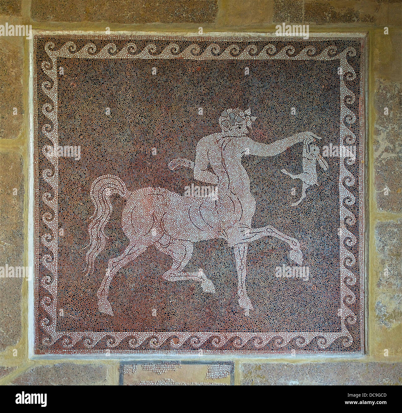 Floor mosaic representing a centaur, from the Acropolis of Rhodes. The cartel says :' The Centaur, ivy-crowned, is depicted at h Stock Photo