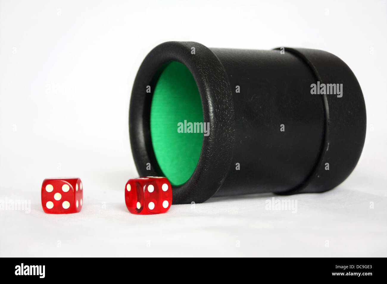 Black Dice Cup with Two Red Dice Stock Photo