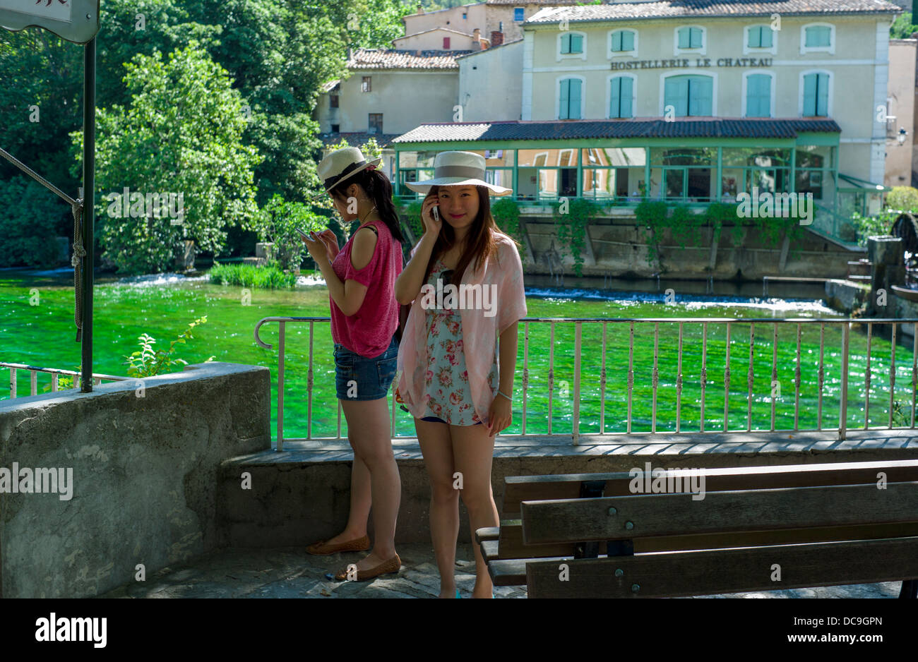 Two Japanese Tourists By the River Sorgue at Fontaine-de-Vaucluse Stock Photo