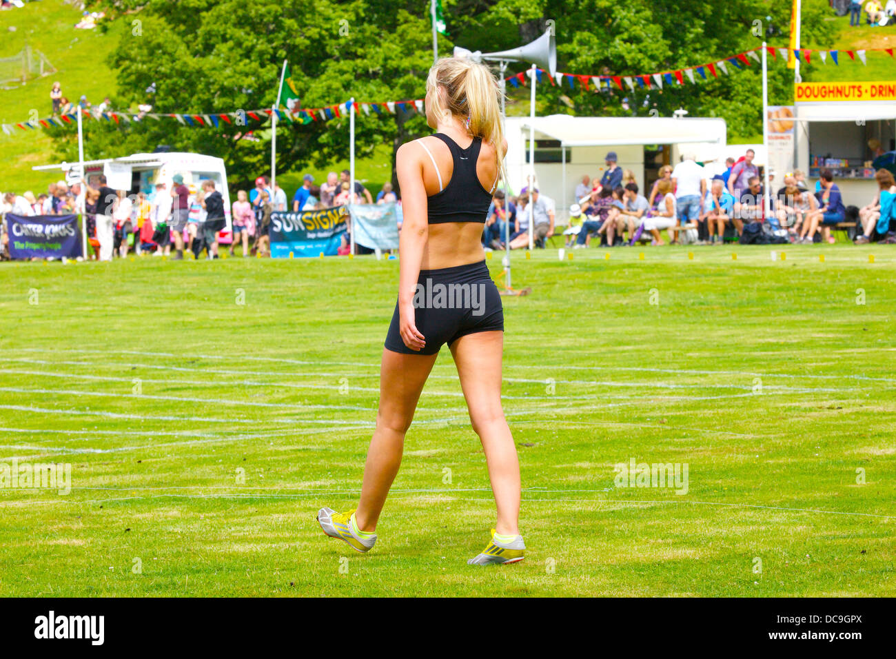 Female runner competing at Ambleside Sports in The Lake District, Cumbria, England, UK Stock Photo
